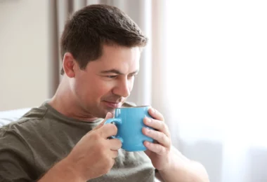 A man drinking kratom tea in a cup