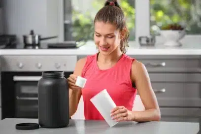 A woman mixing her energy drink with kratom powder for energy booster