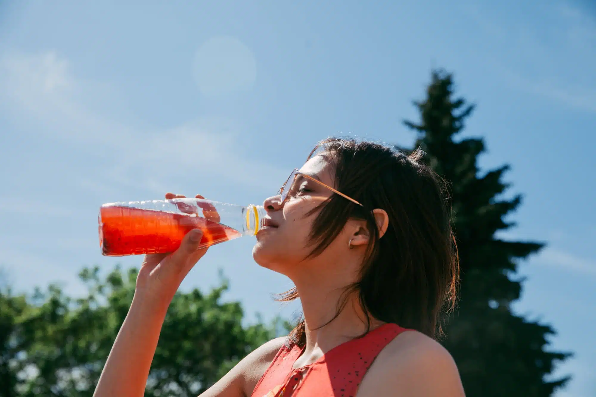 A person drinking juice after taking kratom