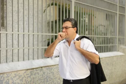 Person holding chest and coughing